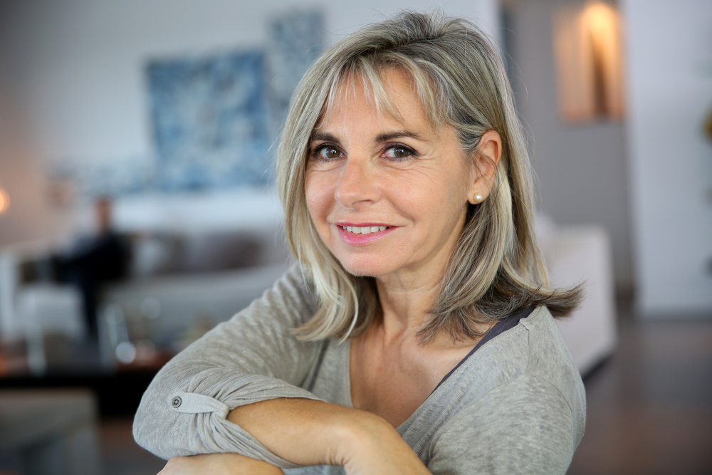 woman smiling while sitting on couch